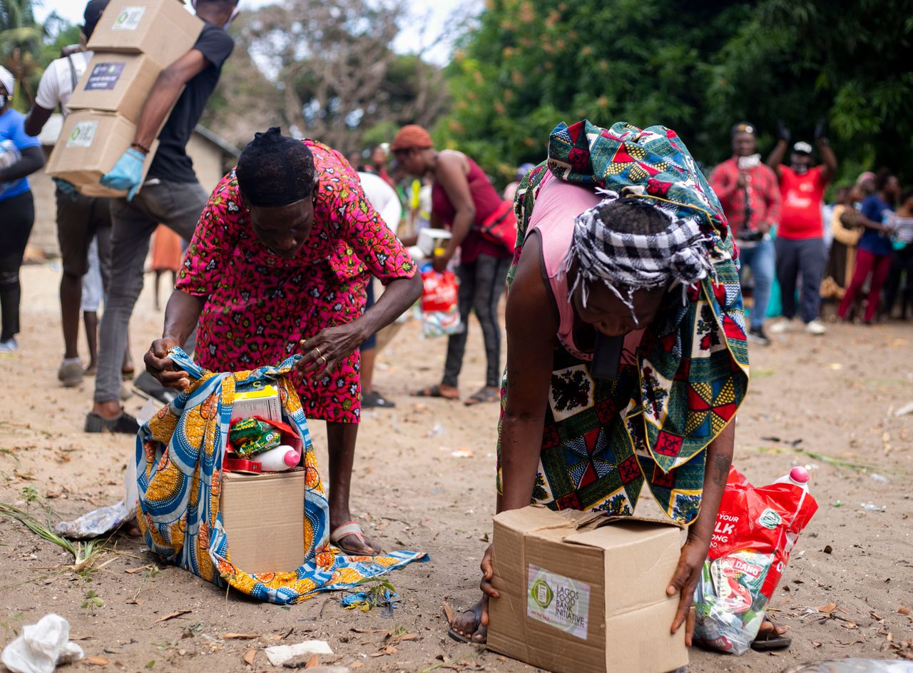 Mastering the First Impression: Your intriguing post title goes here People collecting relief supplies in a community outdoor setting.